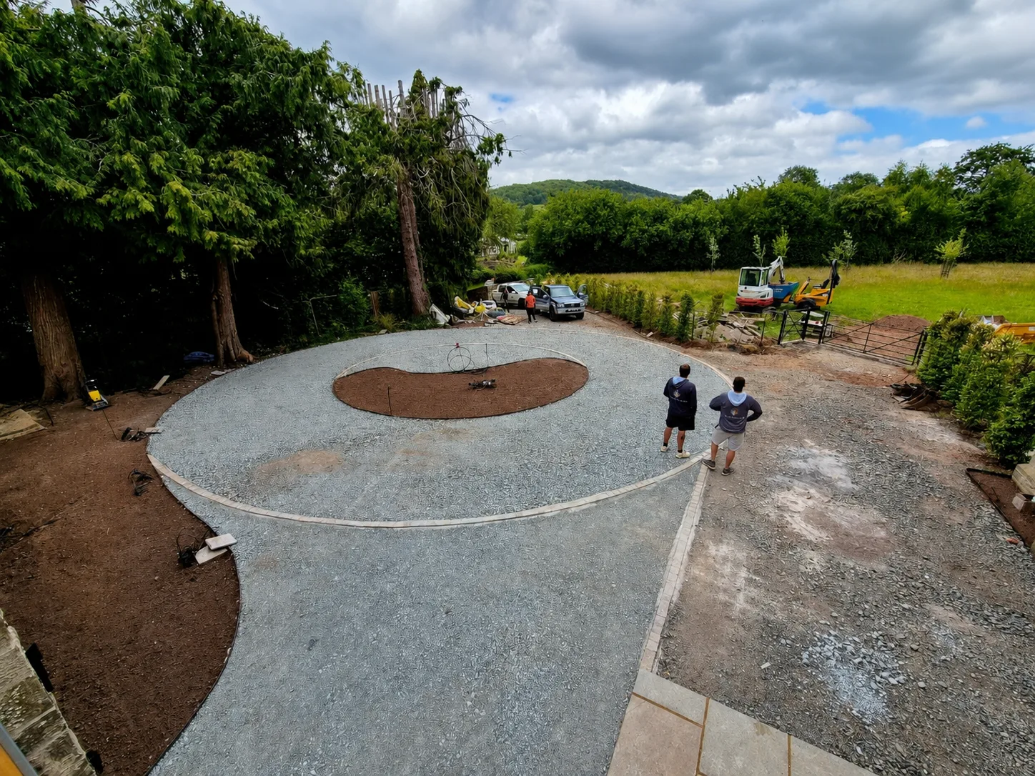 Circular driveway under construction with prepared sub-base and stone edging